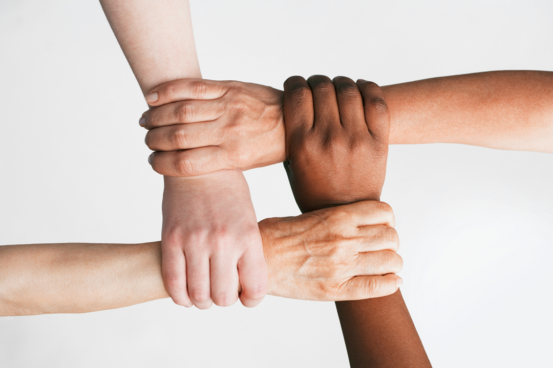Several hands on top of one another
