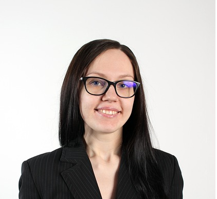 a young woman dressed causally and smiling at the camera