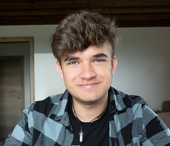 a young man smiling at the camera
